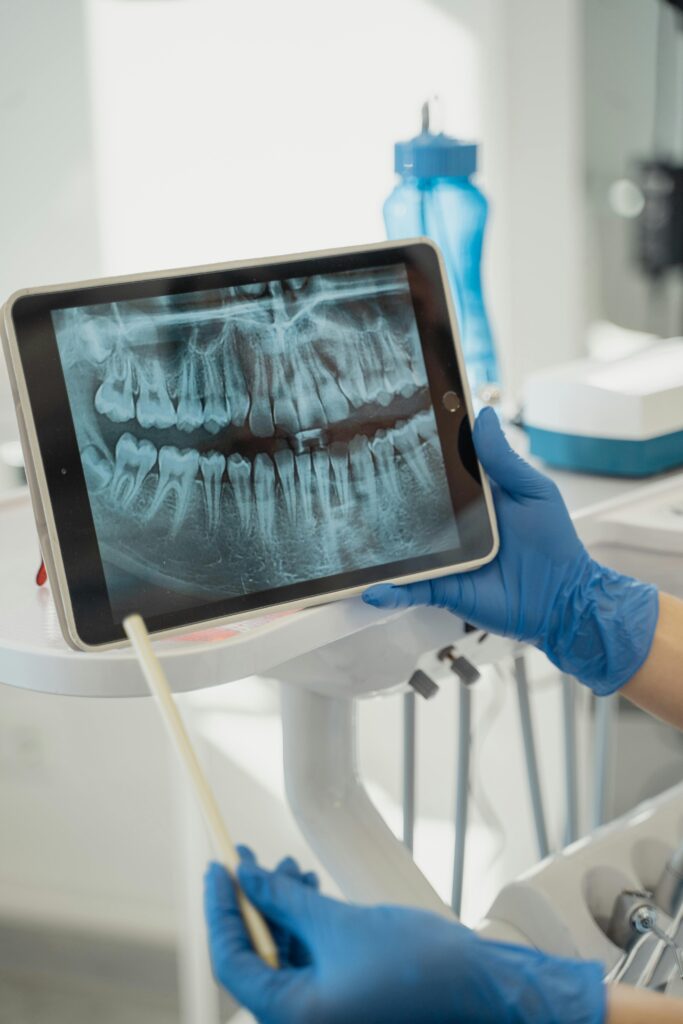 Dentist displaying dental x-ray on tablet in a modern clinic.